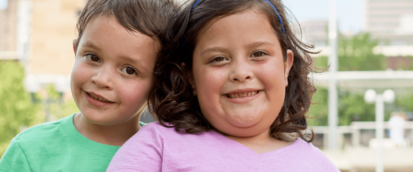 Siblings smile.