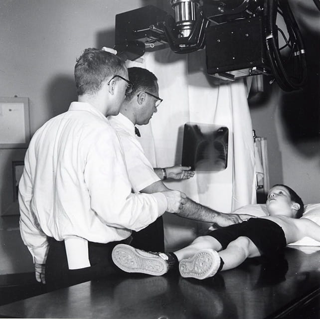 Fred Silverman, MD (center), shown here with Corning Benton, MD, circa 1950, read a patient’s X-ray.