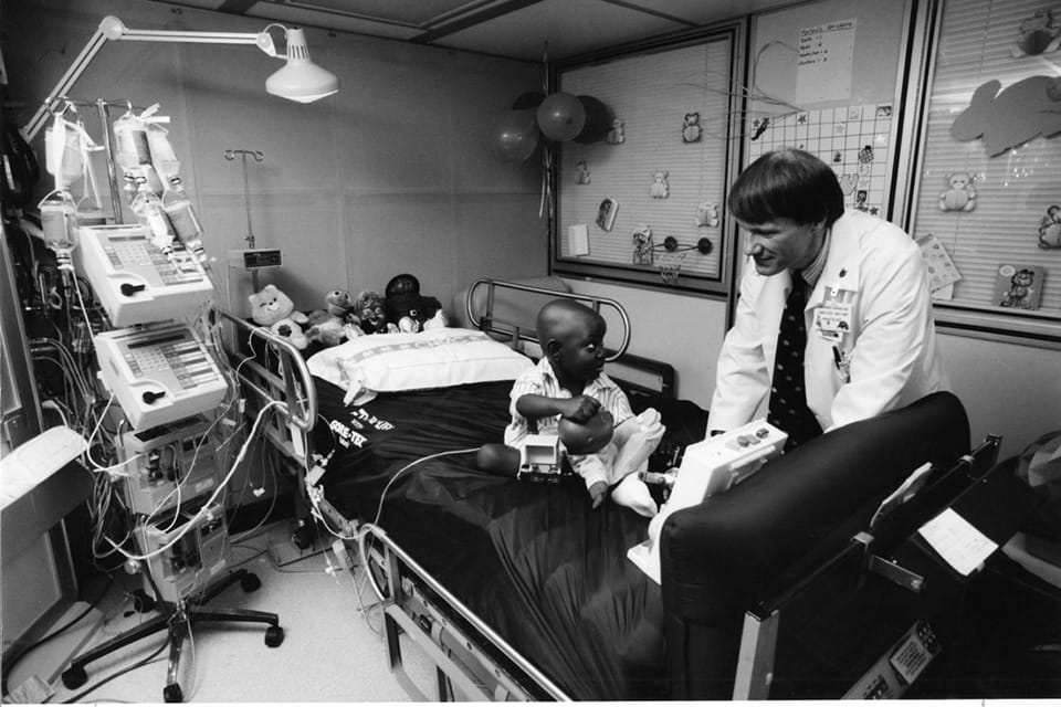 Richard Harris, MD, checks on 3-year-old Marlow Robinson.