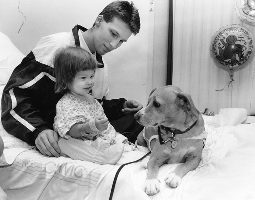 Edith Markoff’s dog, Dusty, visits Molly Hicks and her father.