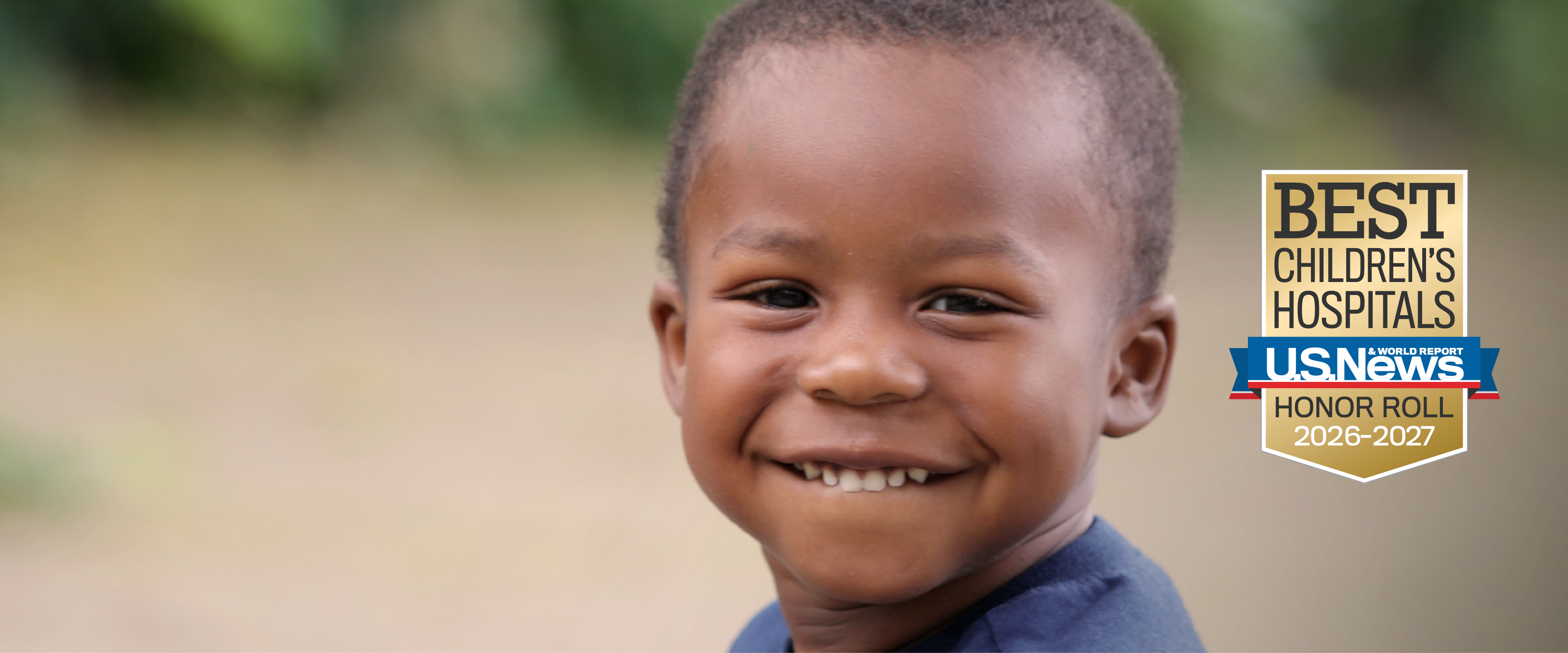 A young boy smiles.
