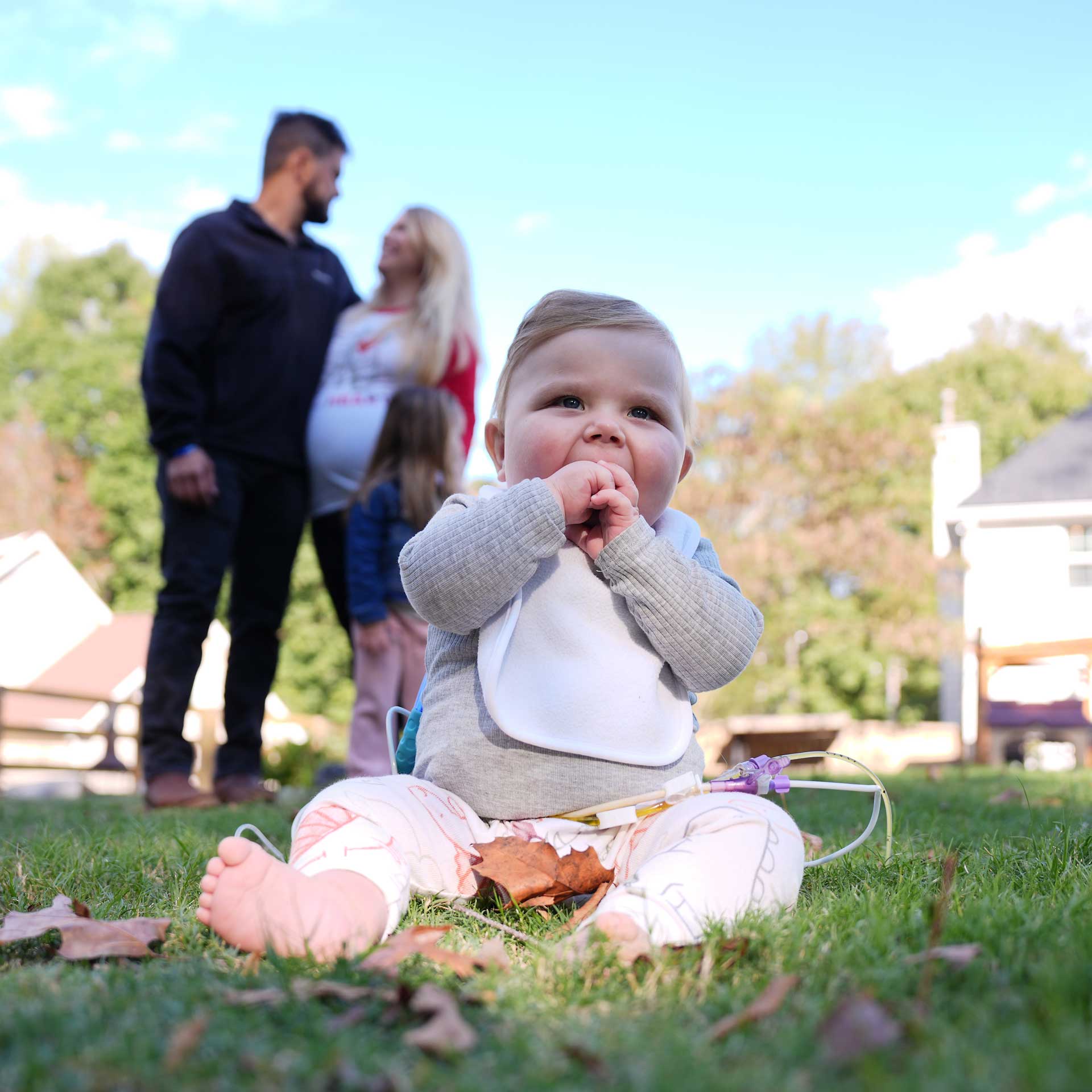 Dylan smiles with his family in the background.