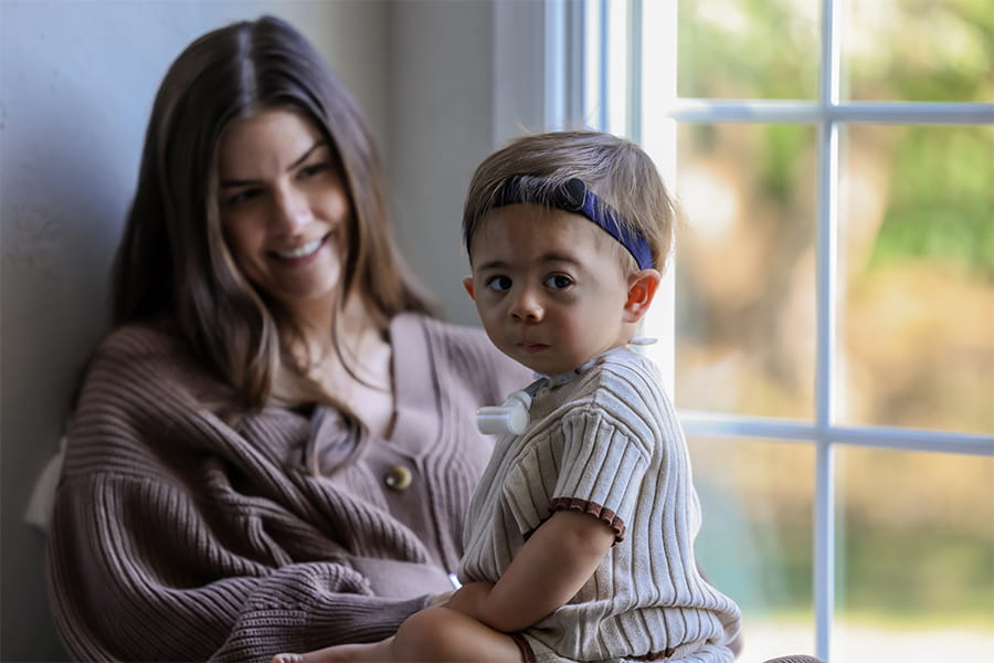 Rami sitting on his mother's lap.