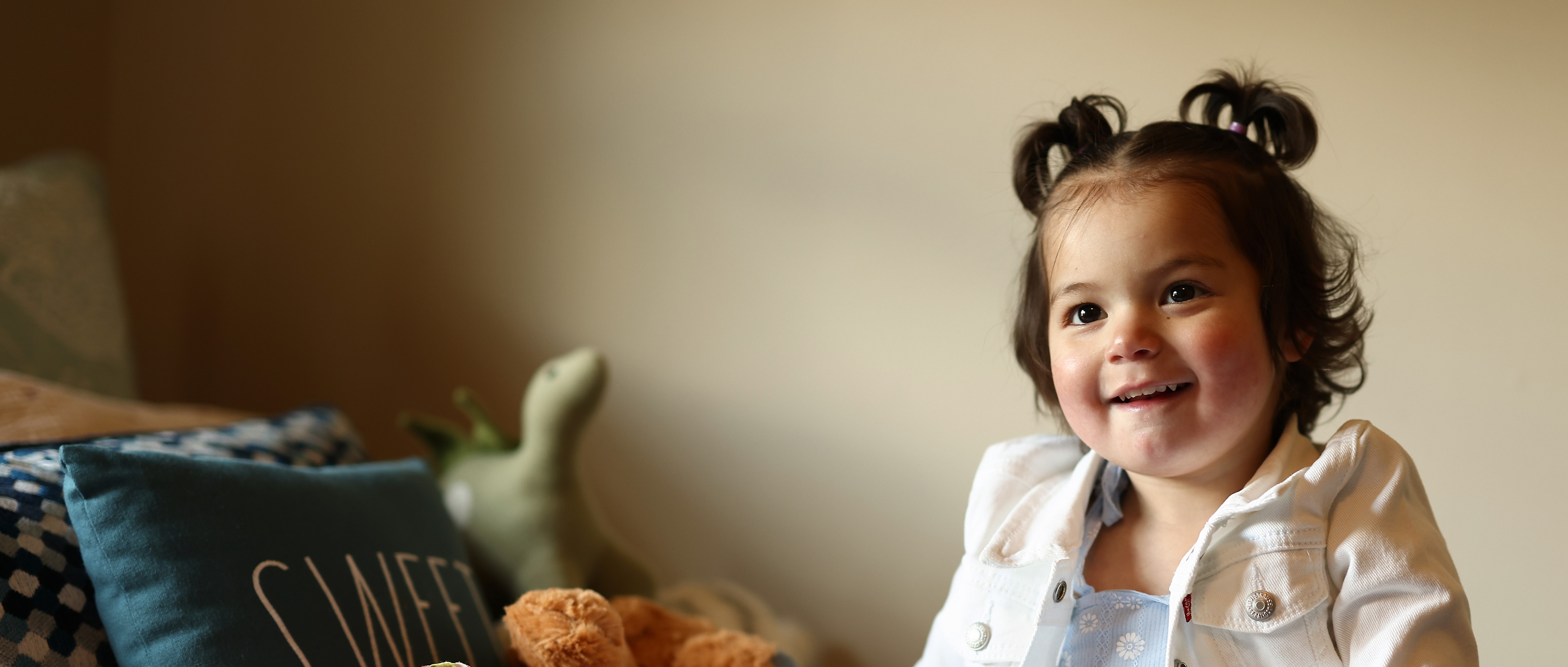 A young girl smiles.