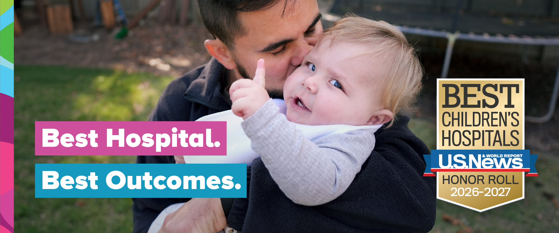 A dad kisses his smiley baby.