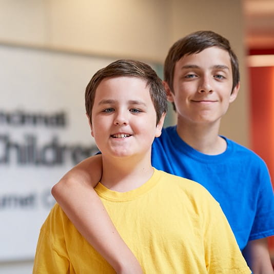 Two brothers smile at Cincinnati Children's.