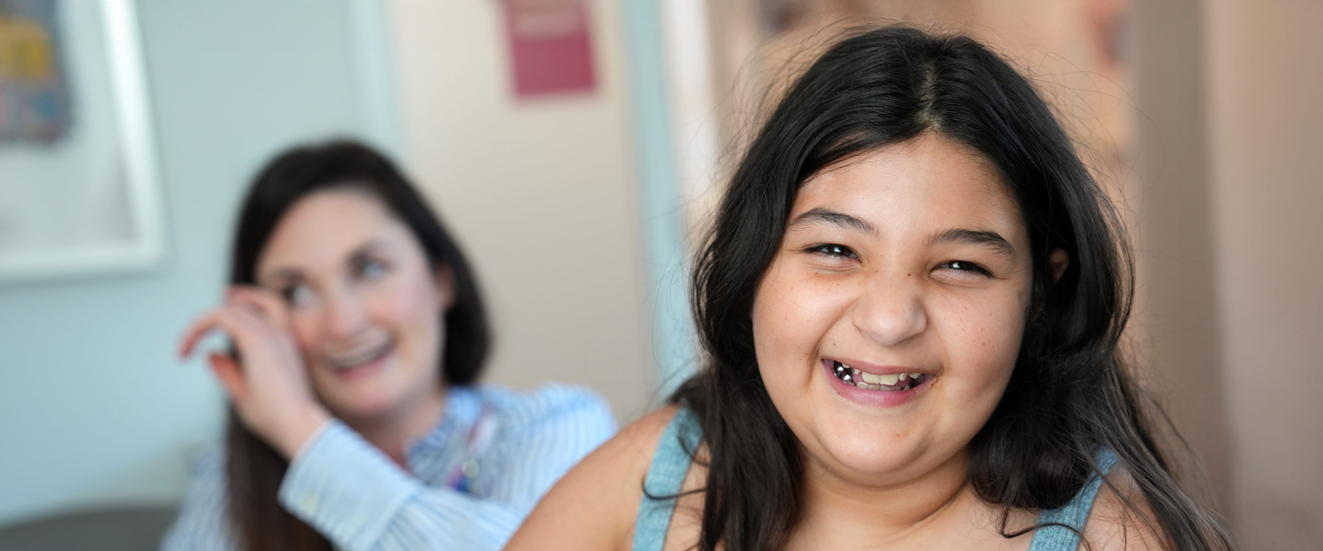 A young girl smiles in a clinic at Cincinnati Children's.