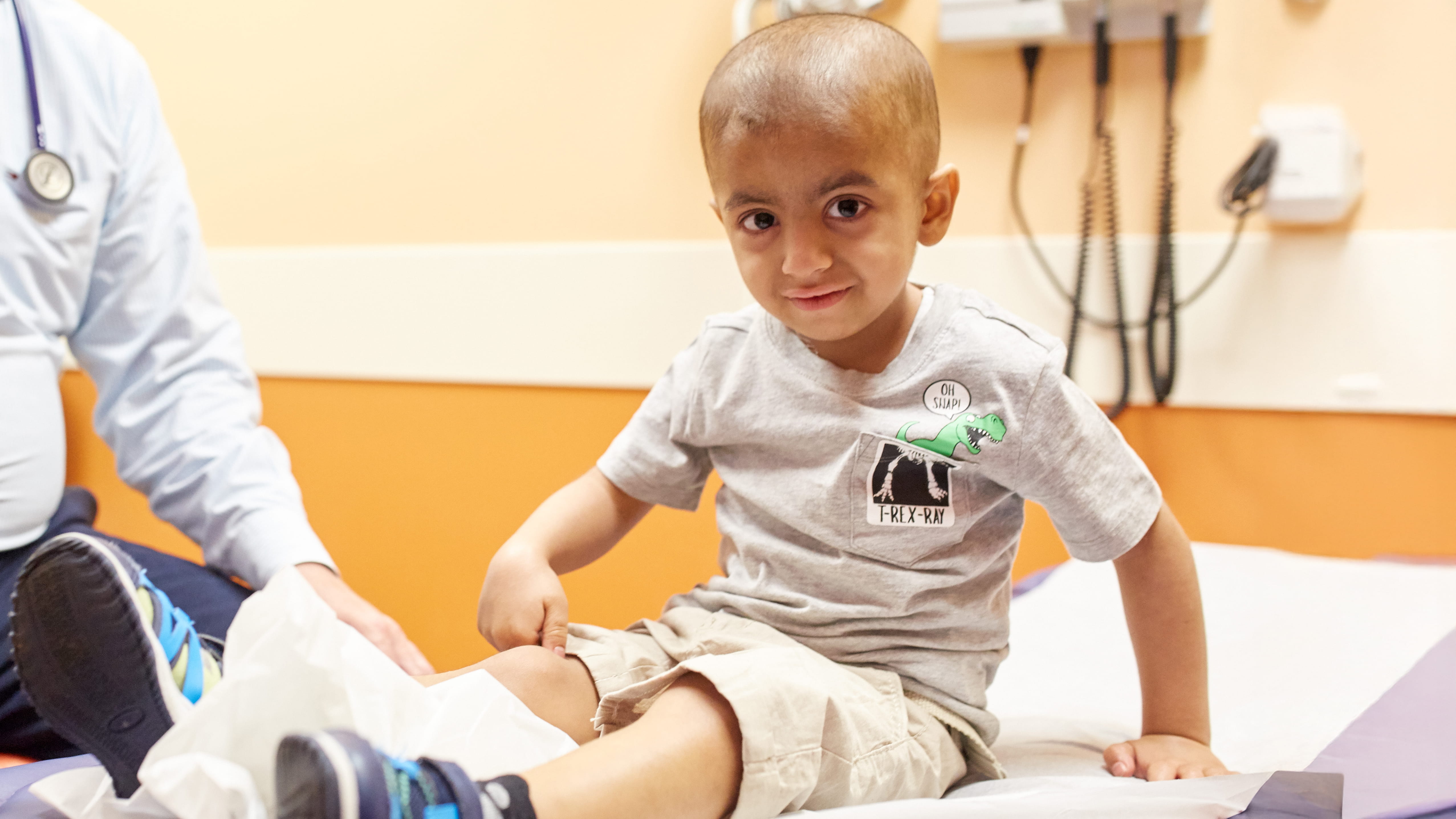 A young boy smiles in a clinic at Cincinnati Children's.