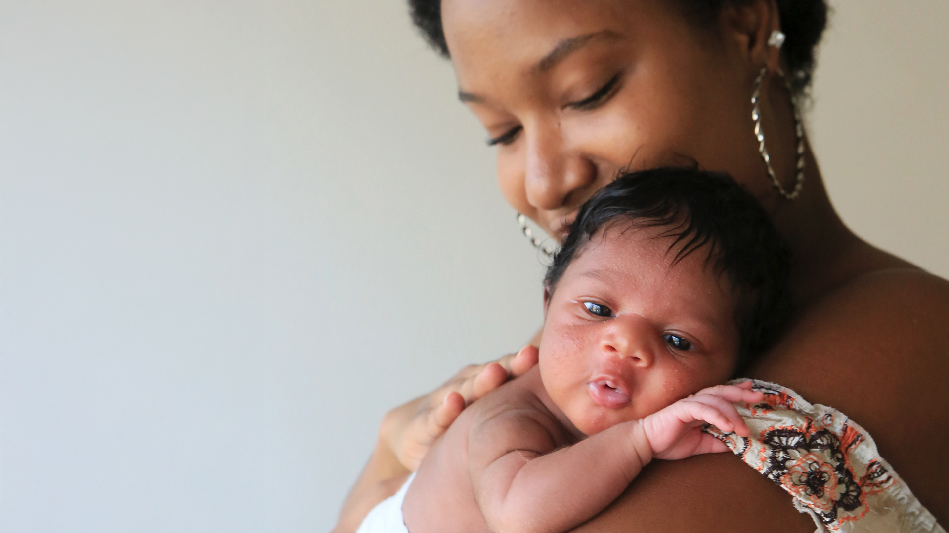 A mother holds her newborn baby.