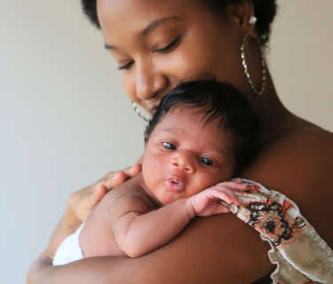 A mother holds her newborn baby.