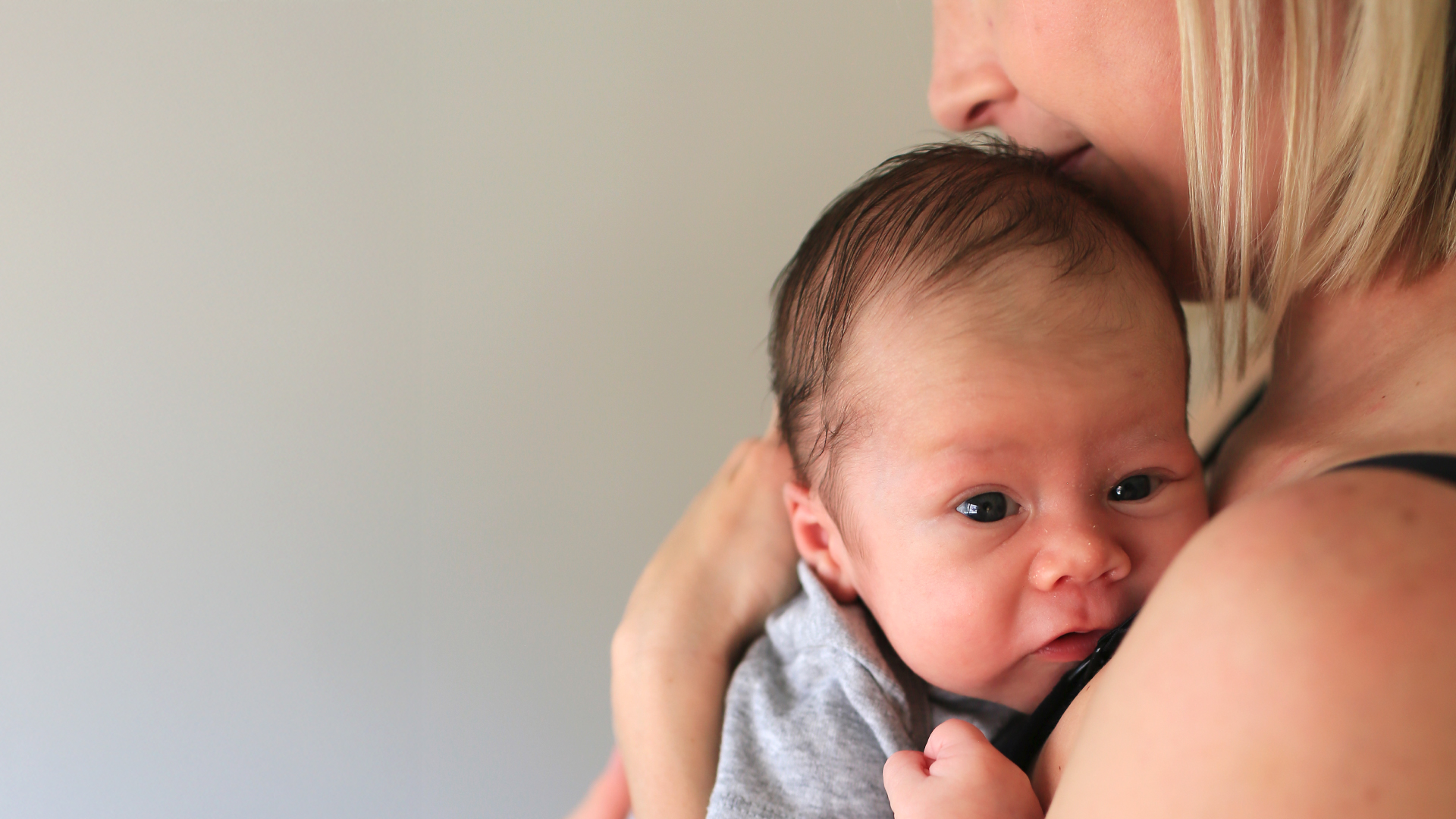 A mother holds her newborn baby.