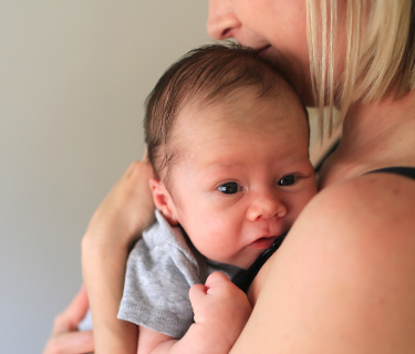 A mother holds her newborn baby.