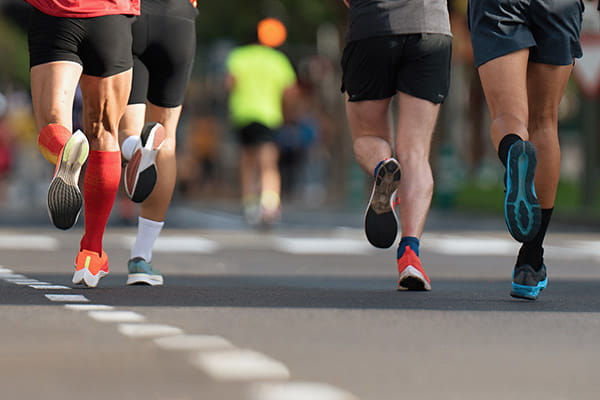 Runners on a city road.