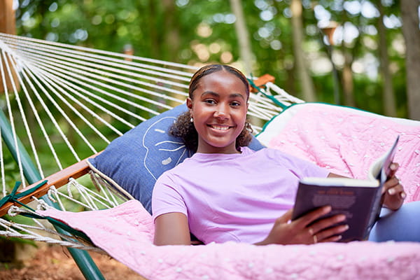 A photo of a girl reading a book.