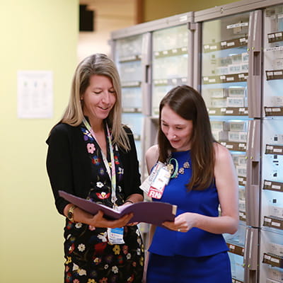 An image of two providers reviewing a chart.
