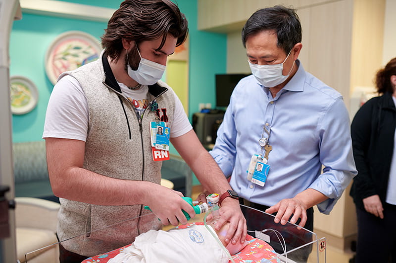 Simulation Center coordinator with staff in the simulation room for education.