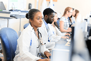An image of residents working on computers.