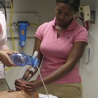 Ayrenne intubating a pediatric simulator.