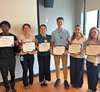 Members of the high school internship group with their certificates.