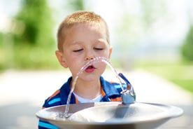 Boy drinking water.