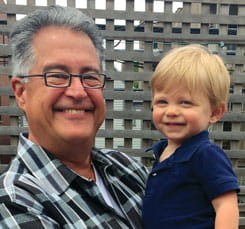 Dan smiles with grandson.