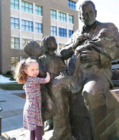 Patient next to Sabin statue. 