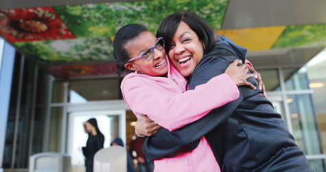 Mom and daughter hug.