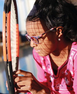 Looking at a tennis racket.