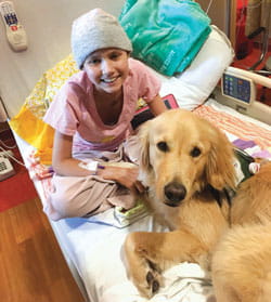 Katie and Chevy in hospital bed.
