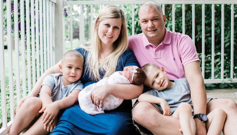 Henry sits with his family.
