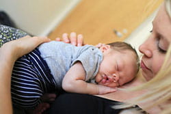 Mom with baby on chest.