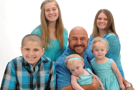 Family smiles for photo.