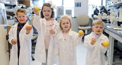 Kids pose for picture in the lab.