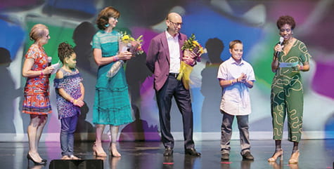 MIchael Fischer on stage with kids and patients.