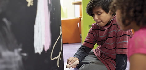 Kids with chalk.