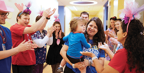 Staff celebrate patient.