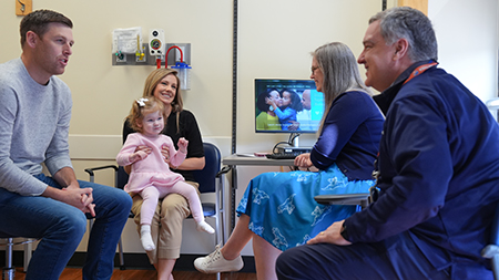 Colette's family meets with specialists in the TSC clinic.
