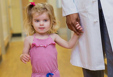 A child holding a doctor's hand.