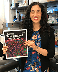 Nurit Azouz, PhD, holding a copy of Science Translational Medicine.