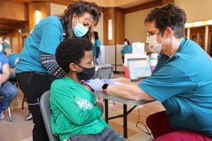 An image of a boy getting his COVID vaccine.