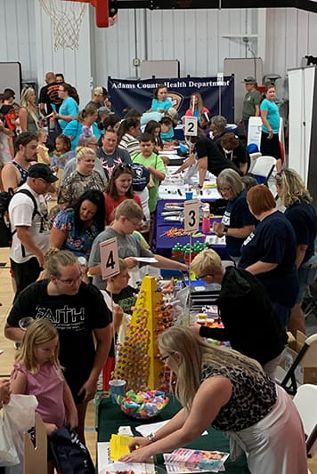 A photo of families enjoying activities at the Adams County health fair.