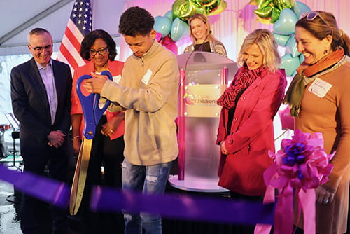 Gabriel Stanton, 14, cuts the ribbon at the dedication of Cincinnati Children's Centerville.