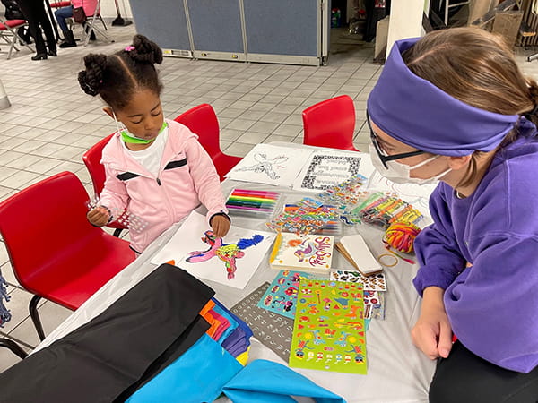 A photo of a Cincinnati Children's provider coloring with a child.