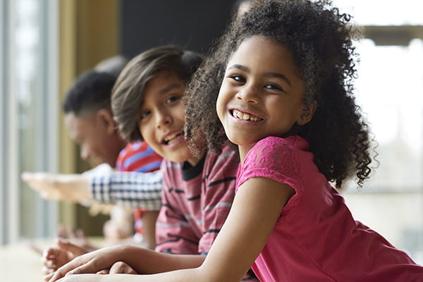 A photo of children smiling.