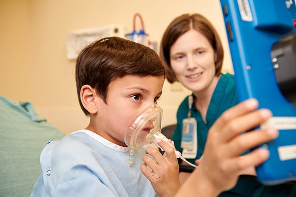 A photo of a patient utilizing a breathing controlled video game that helps patients relax during anesthesia.