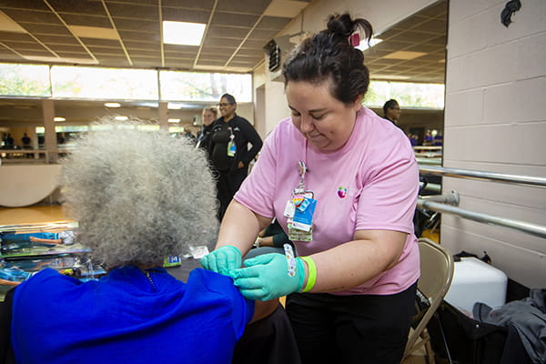 Woman administering a vaccine.