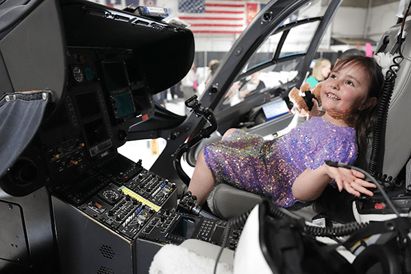 Ellie smiles inside the Cincinnati Children's helicopter.