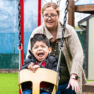 A photo of a child on a swing.