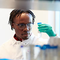 A photo of a researcher examining a test tube.