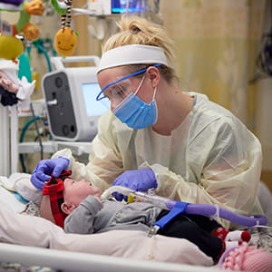 A photo of a baby receiving respiratory therapy.